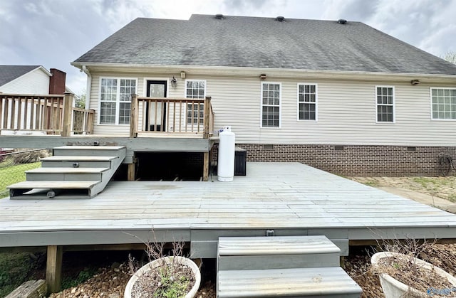 back of house with crawl space, a shingled roof, and a wooden deck
