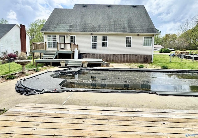 back of property featuring fence, a wooden deck, crawl space, and roof with shingles