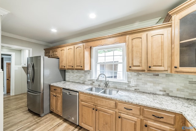 2600 Gawain Rd SE, Huntsville, AL 35803 - kitchen with appliances with stainless steel finishes, light wood-type flooring, crown molding, decorative backsplash, and light stone counters