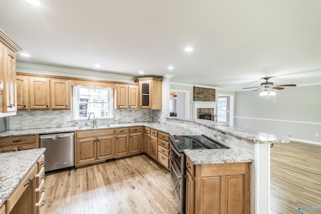 2600 Gawain Rd SE, Huntsville, AL 35803 - kitchen featuring appliances with stainless steel finishes, light wood finished floors, a peninsula, healthy amount of natural light, and crown molding