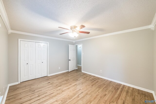 2600 Gawain Rd SE, Huntsville, AL 35803 - unfurnished bedroom featuring a textured ceiling, light wood-style flooring, ornamental molding, a closet, and ceiling fan
