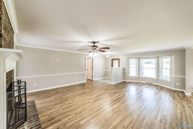 2600 Gawain Rd SE, Huntsville, AL 35803 - unfurnished living room with a ceiling fan, wood finished floors, a fireplace, and crown molding