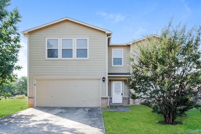 view of front of property featuring a front lawn and a garage