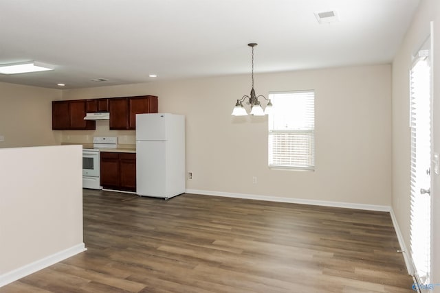 kitchen featuring wood-type flooring, an inviting chandelier, decorative light fixtures, and white appliances