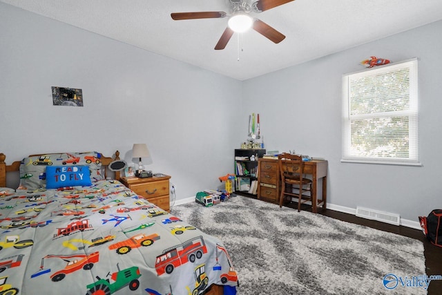 bedroom with visible vents, baseboards, and ceiling fan