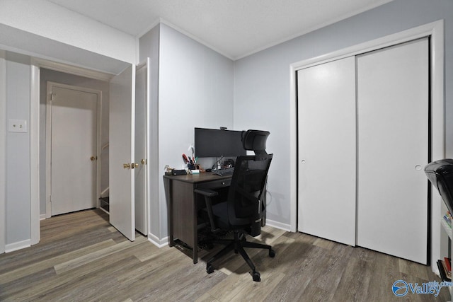office with crown molding, wood finished floors, and baseboards