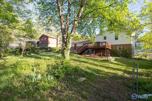 view of yard with a deck and stairway