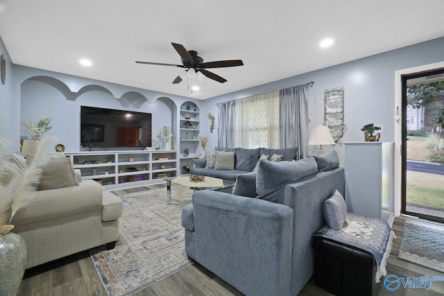 living area with ceiling fan, recessed lighting, plenty of natural light, and wood finished floors