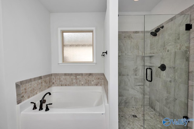 full bathroom with a stall shower and a garden tub