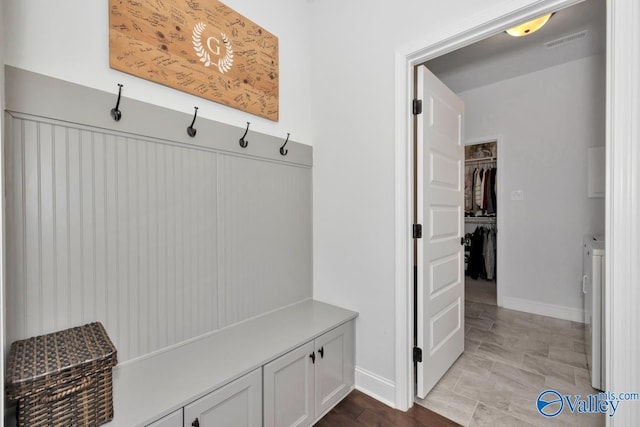 mudroom featuring washer / clothes dryer, visible vents, and baseboards