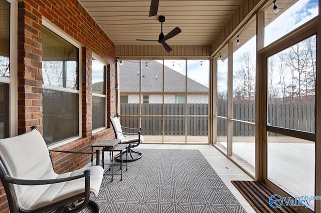 sunroom featuring ceiling fan