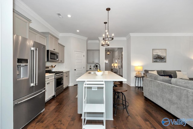 kitchen with gray cabinetry, stainless steel appliances, a sink, visible vents, and light countertops