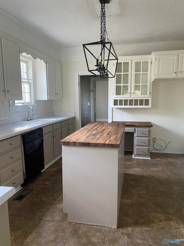 kitchen featuring butcher block counters, a kitchen island, decorative light fixtures, black dishwasher, and white cabinets