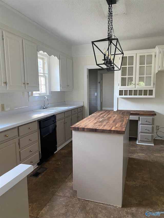 kitchen with a center island, dishwasher, white cabinets, hanging light fixtures, and butcher block countertops