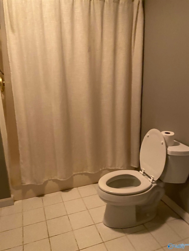 bathroom featuring toilet and tile patterned floors