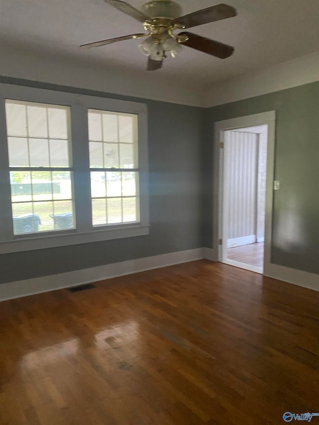 unfurnished room featuring ceiling fan and dark hardwood / wood-style flooring