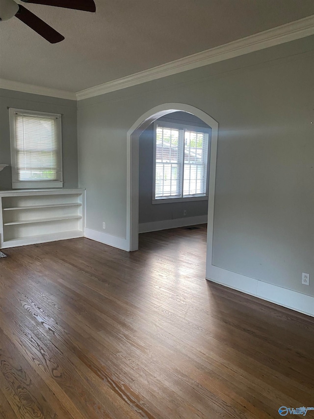 spare room with a textured ceiling, dark hardwood / wood-style flooring, ceiling fan, and crown molding