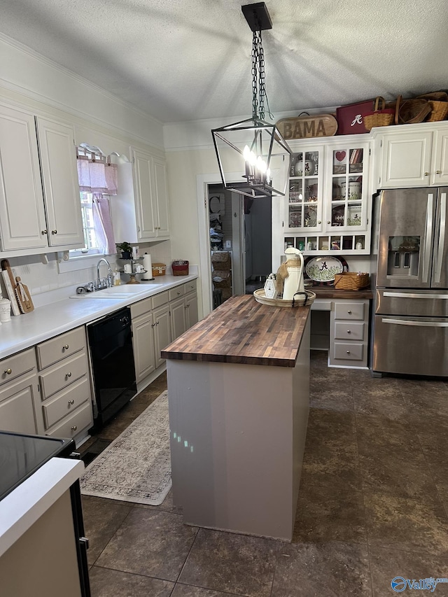 kitchen with a sink, wood counters, stainless steel fridge, a kitchen island, and dishwasher