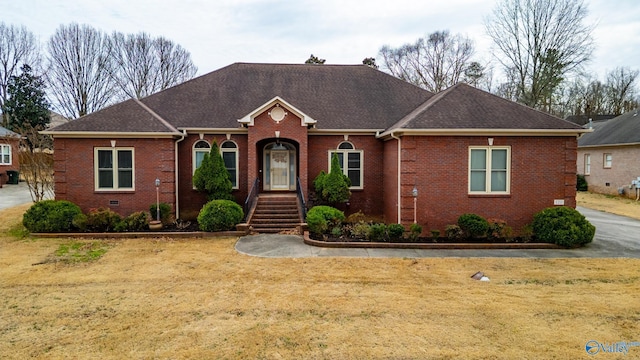 ranch-style home featuring brick siding, crawl space, and a shingled roof