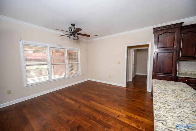 unfurnished living room with crown molding, baseboards, and dark wood-style flooring