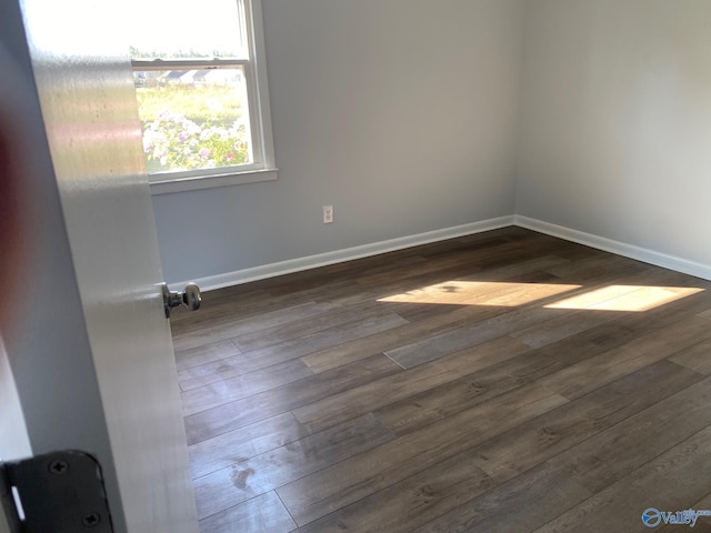 unfurnished room featuring dark hardwood / wood-style floors