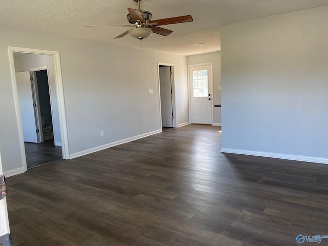 spare room with ceiling fan, dark wood-type flooring, and a textured ceiling