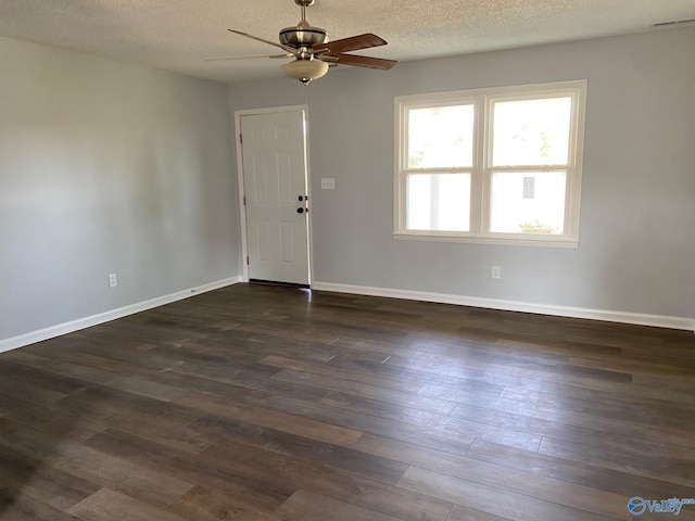 unfurnished room with ceiling fan, dark wood-type flooring, and a textured ceiling