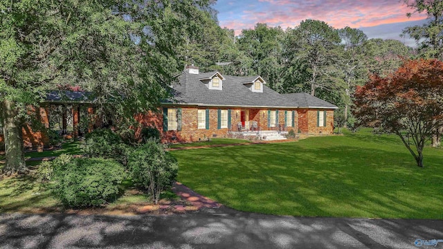 8601 County Road 214, Trinity, AL 35673 - view of front facade featuring brick siding, a chimney, and a front yard