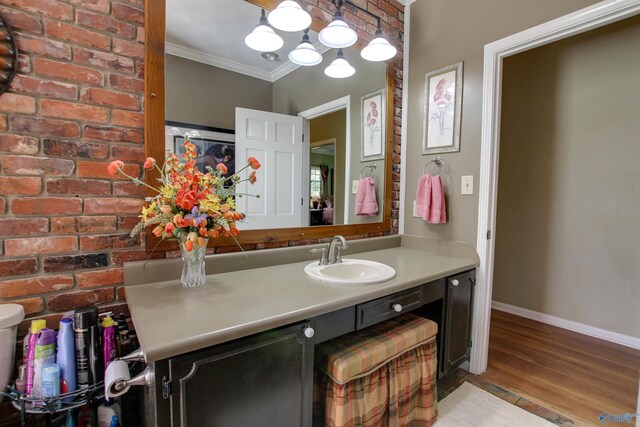 8601 County Road 214, Trinity, AL 35673 - bathroom with crown molding, vanity, wood finished floors, baseboards, and brick wall