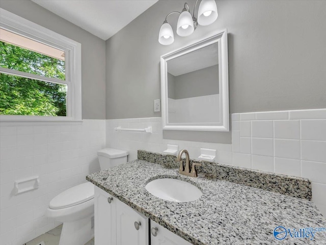 2612 Valley Brook Dr, Huntsville, AL 35811 - bathroom with tile walls, vanity, and a wainscoted wall