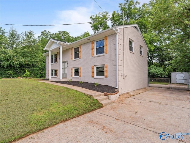 2612 Valley Brook Dr, Huntsville, AL 35811 - view of front of house featuring brick siding, driveway, and a gate