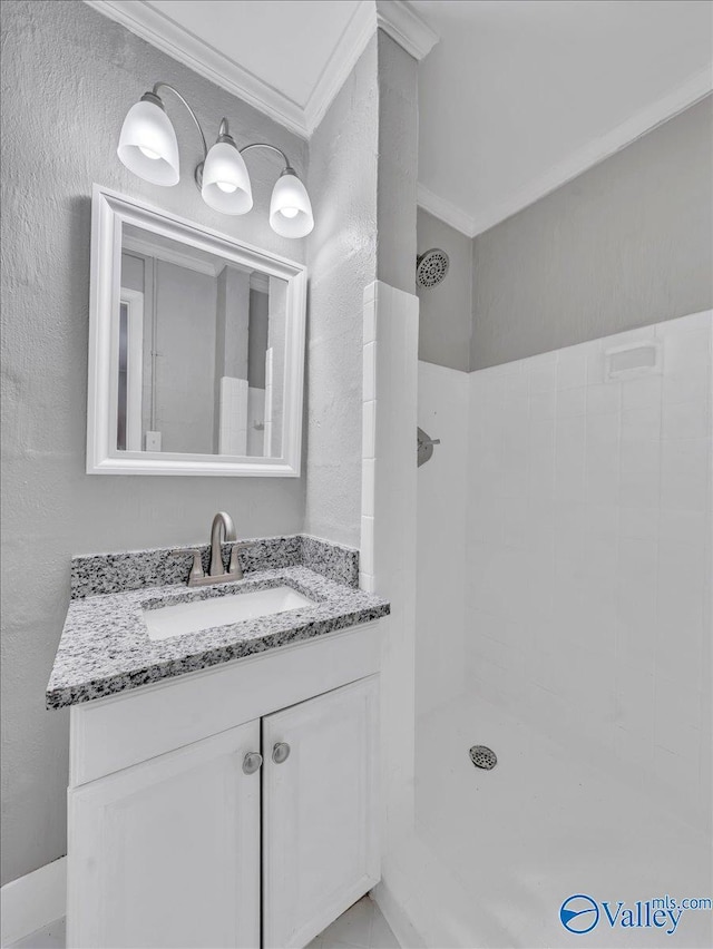 2612 Valley Brook Dr, Huntsville, AL 35811 - full bath with crown molding, a tile shower, vanity, and a textured wall