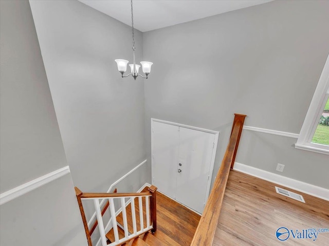 2612 Valley Brook Dr, Huntsville, AL 35811 - staircase featuring wood finished floors and a chandelier
