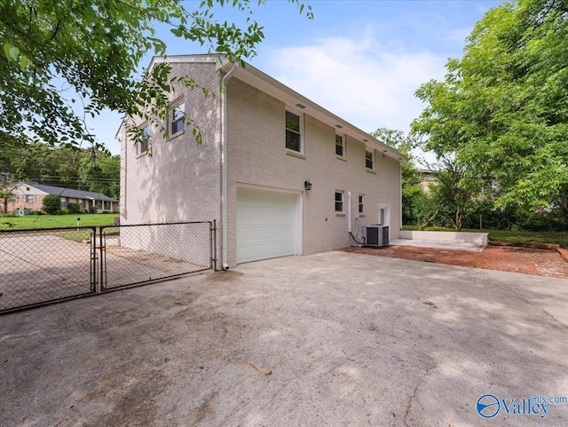 2612 Valley Brook Dr, Huntsville, AL 35811 - view of side of property with a garage, a gate, driveway, and brick siding