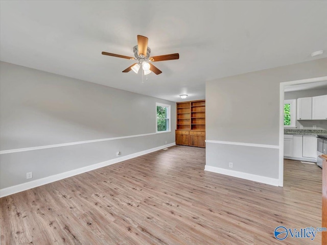 2612 Valley Brook Dr, Huntsville, AL 35811 - spare room featuring ceiling fan, light wood-style flooring, plenty of natural light, and built in shelves