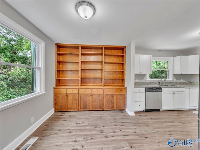 2612 Valley Brook Dr, Huntsville, AL 35811 - kitchen with stainless steel dishwasher, plenty of natural light, white cabinetry, and light wood finished floors