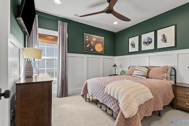 bedroom with visible vents, light colored carpet, ceiling fan, a decorative wall, and recessed lighting