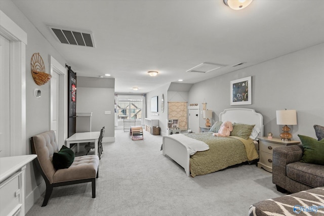 bedroom with attic access, visible vents, baseboards, and light colored carpet