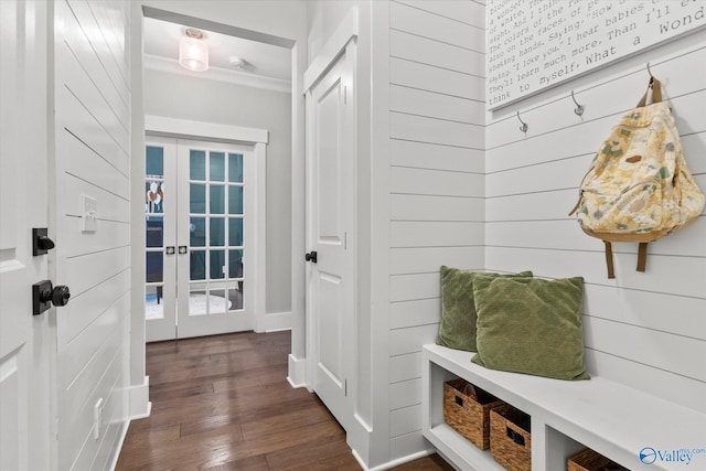 mudroom featuring dark wood-style floors, wooden walls, and french doors