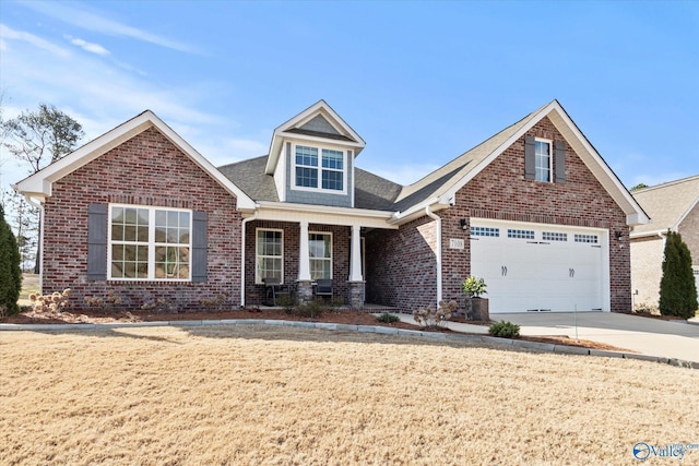 view of front of house with brick siding, concrete driveway, covered porch, an attached garage, and a front lawn