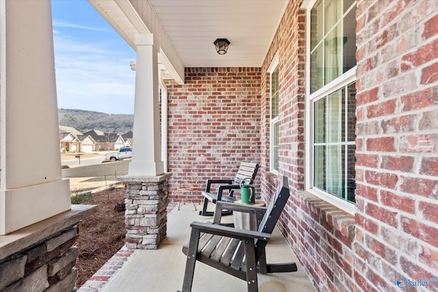 view of patio / terrace with covered porch and a mountain view