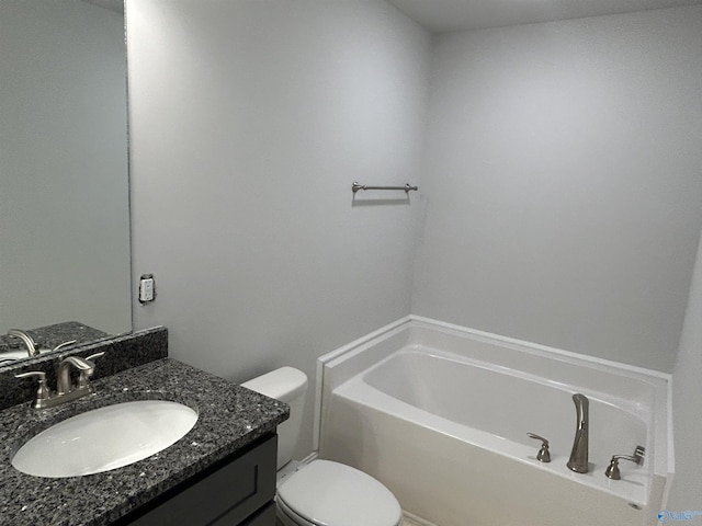 bathroom featuring toilet, vanity, and a garden tub