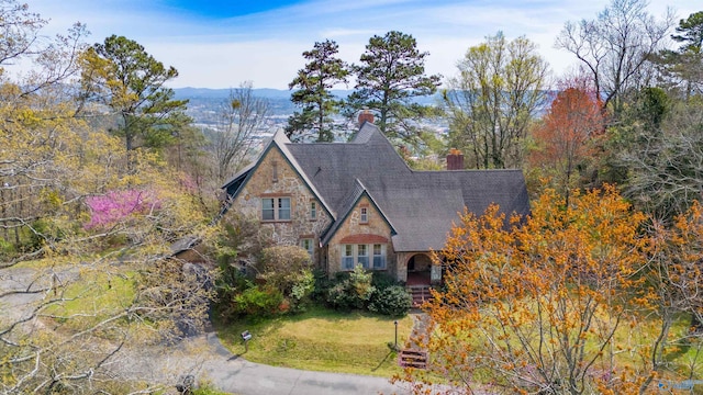 tudor home featuring a front lawn