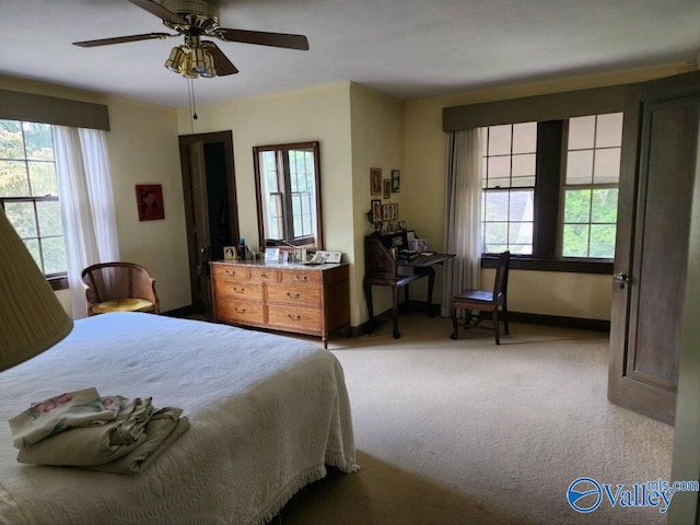 bedroom featuring a ceiling fan and light colored carpet