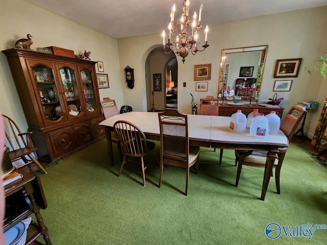 carpeted dining area featuring a chandelier