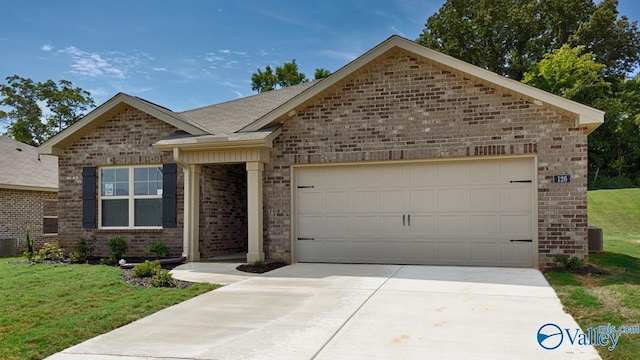 single story home featuring an attached garage, brick siding, a shingled roof, concrete driveway, and a front lawn