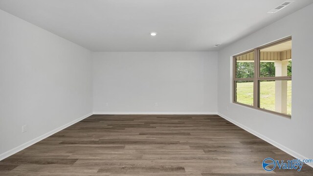 spare room featuring visible vents, baseboards, wood finished floors, and recessed lighting