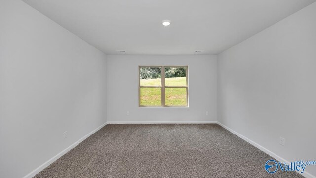 spare room with carpet floors and baseboards
