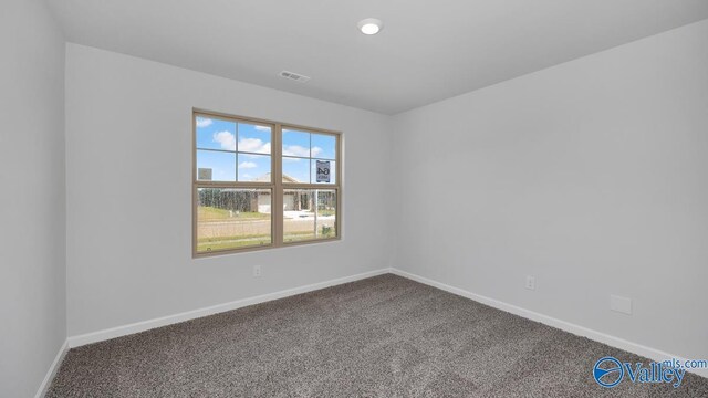 carpeted empty room featuring baseboards, visible vents, and recessed lighting