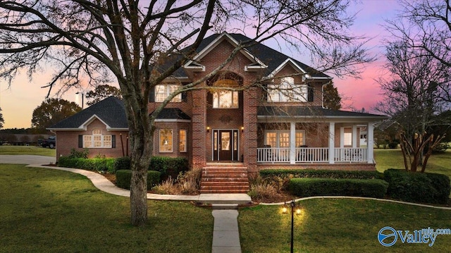 view of front of house with a yard and covered porch